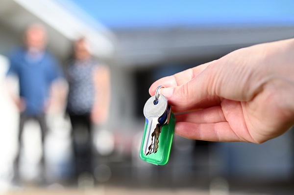 Real estate agent handing keys to a new home owners